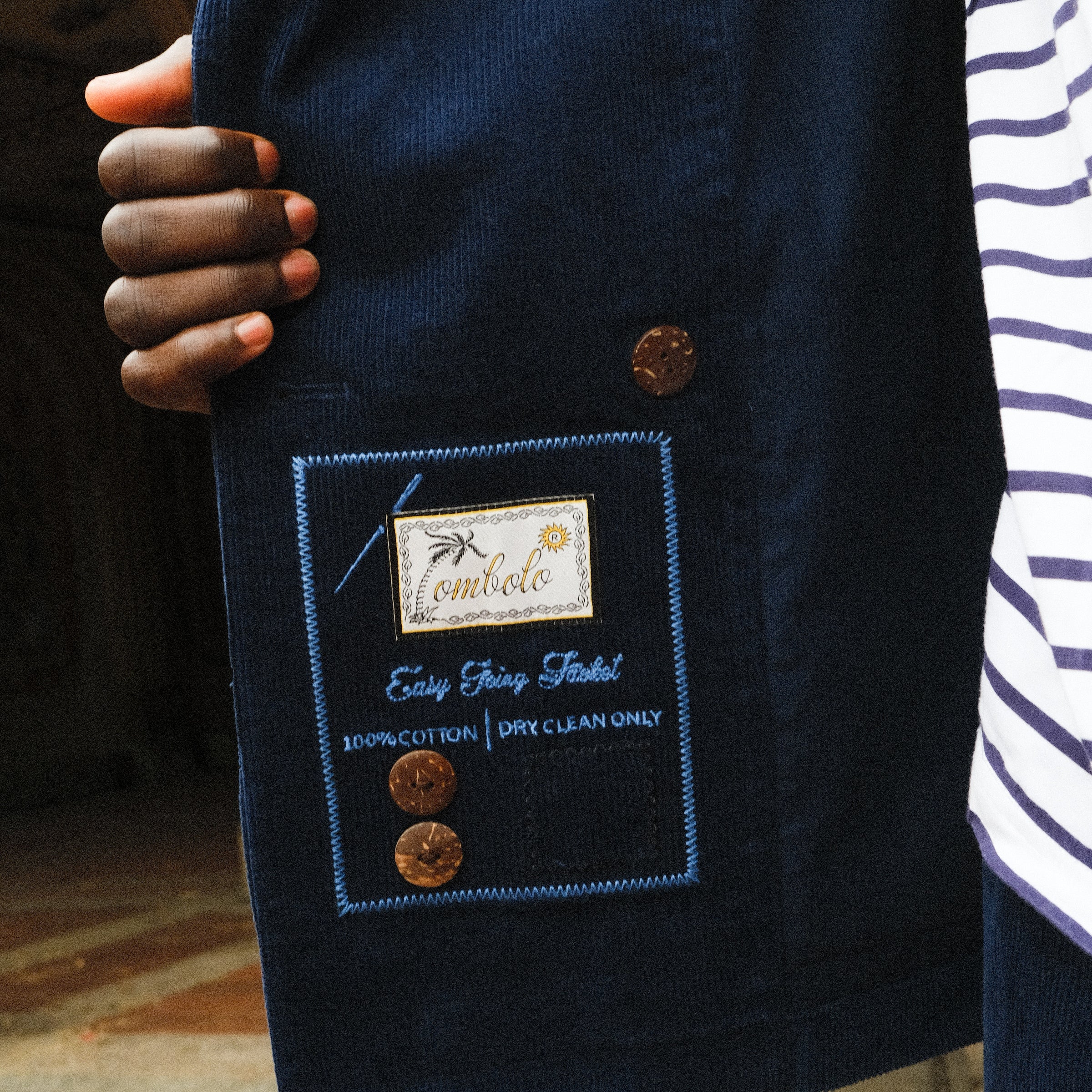 Image of the interior label on the Navy Corduroy Jacket. 