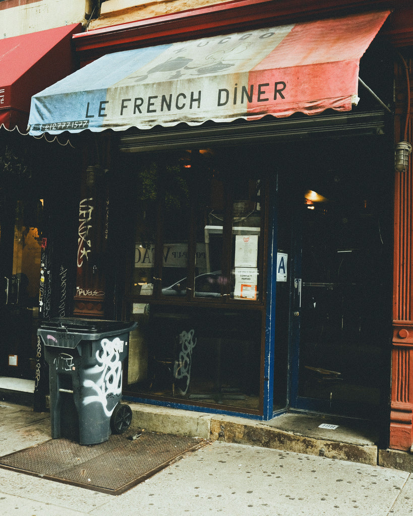 'Le French Diner' storefront featuring red white and blue awning.