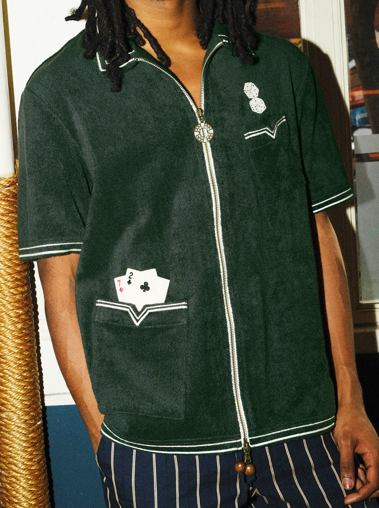 Close up of male model wearing Green Terry Cloth Cabana Shirt, with right hand in pocket. His face is cutout of this image.
