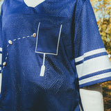 Close-up of a blue mesh jersey's front pocket.
