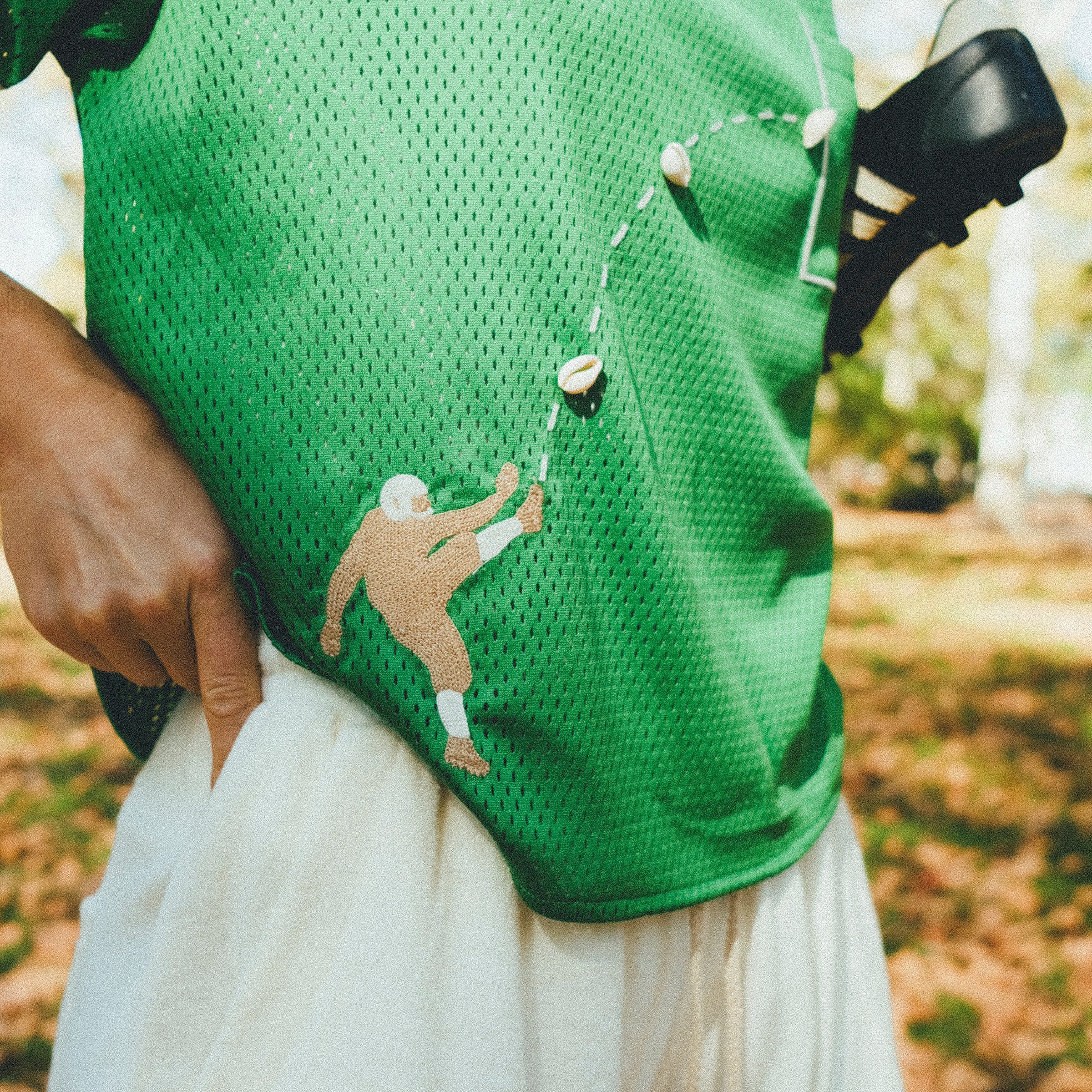 Close-up of football player embroidery on the green mesh jersey.