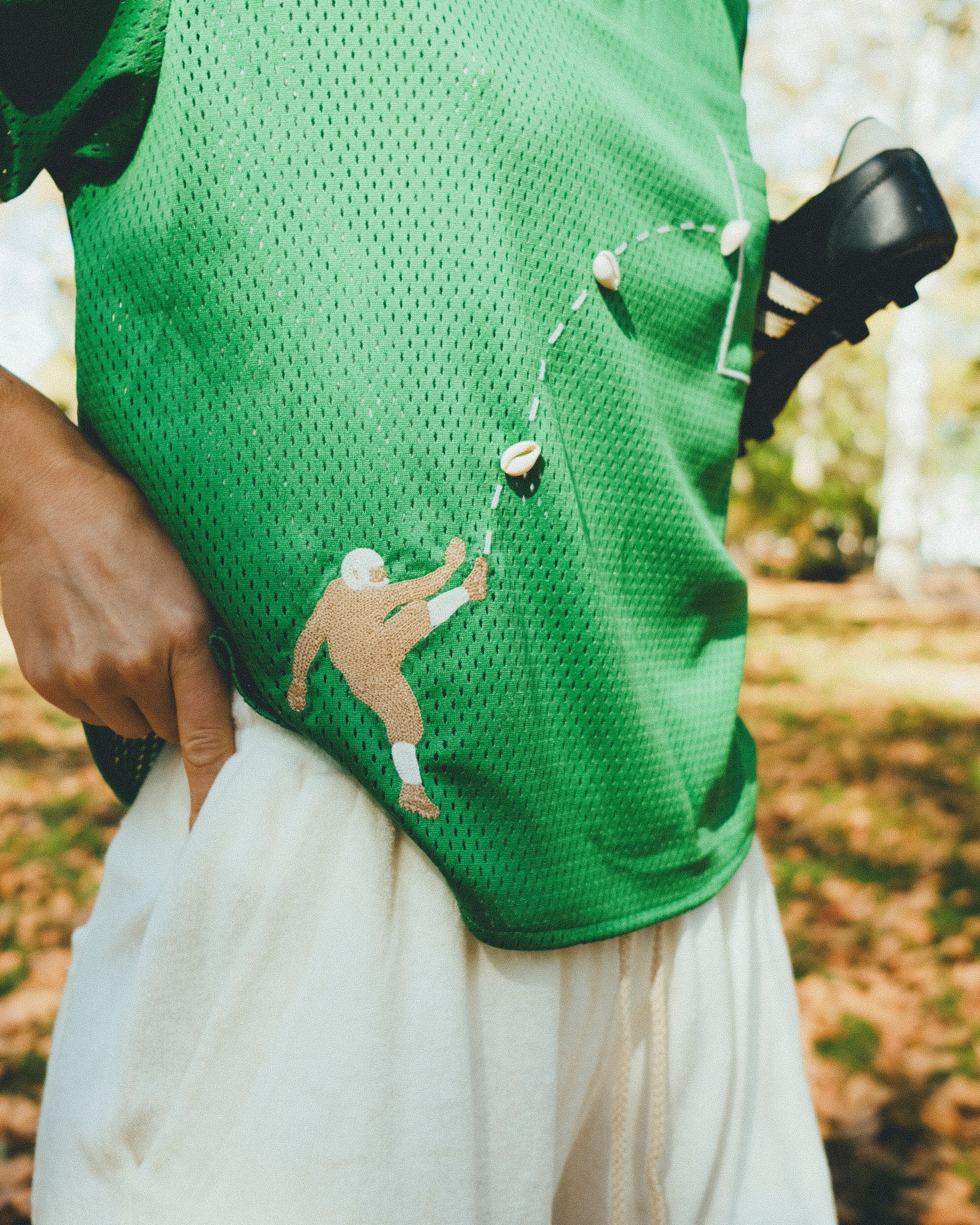 Close-up of football player embroidery on the green mesh jersey.