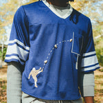 Close-up of a man wearing the blue mesh football jersey.