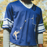 Close-up of a man wearing the blue mesh football jersey.