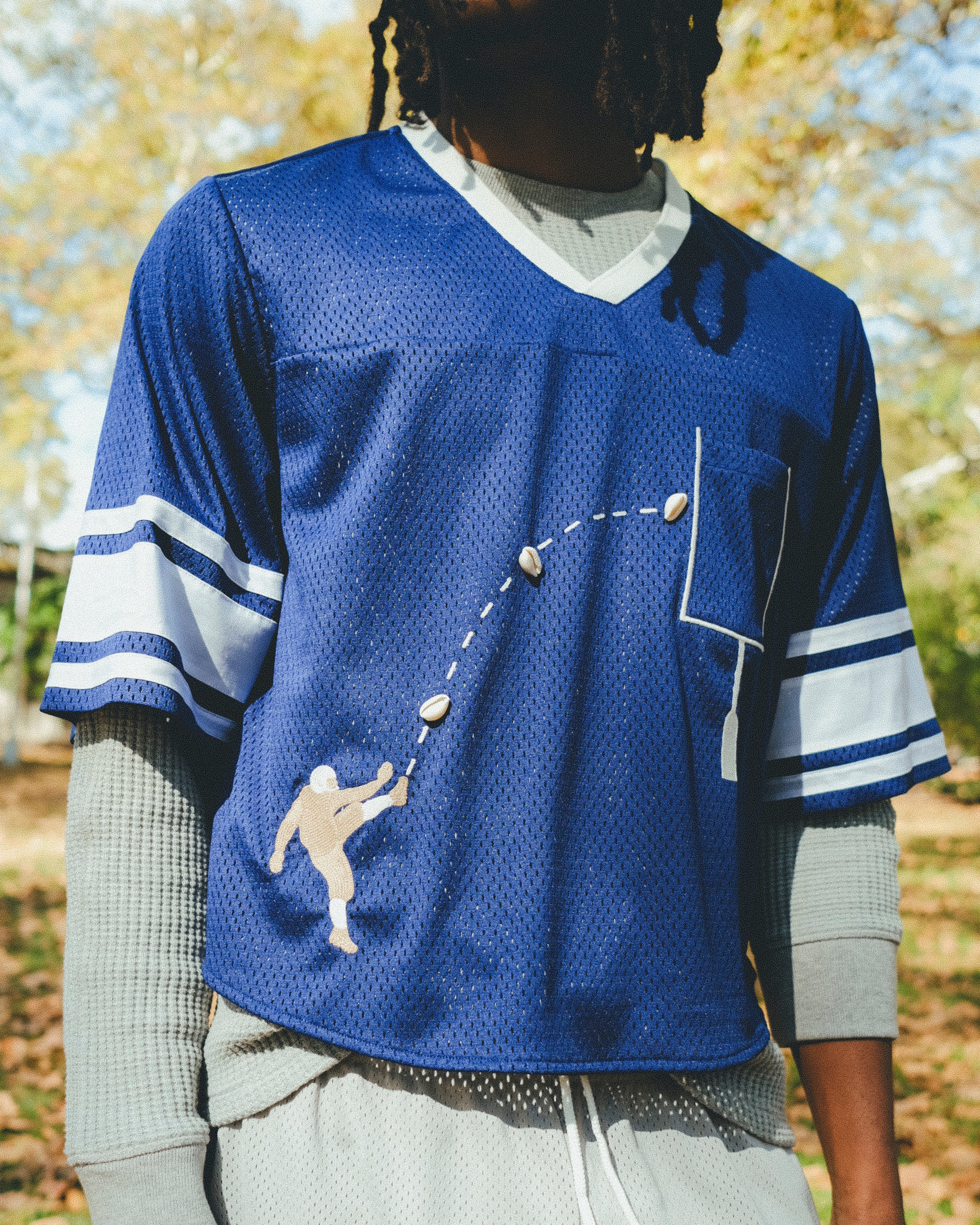 Close-up of a man wearing the blue mesh football jersey.