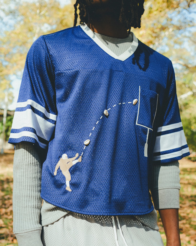 Close-up of a man wearing the blue mesh football jersey.