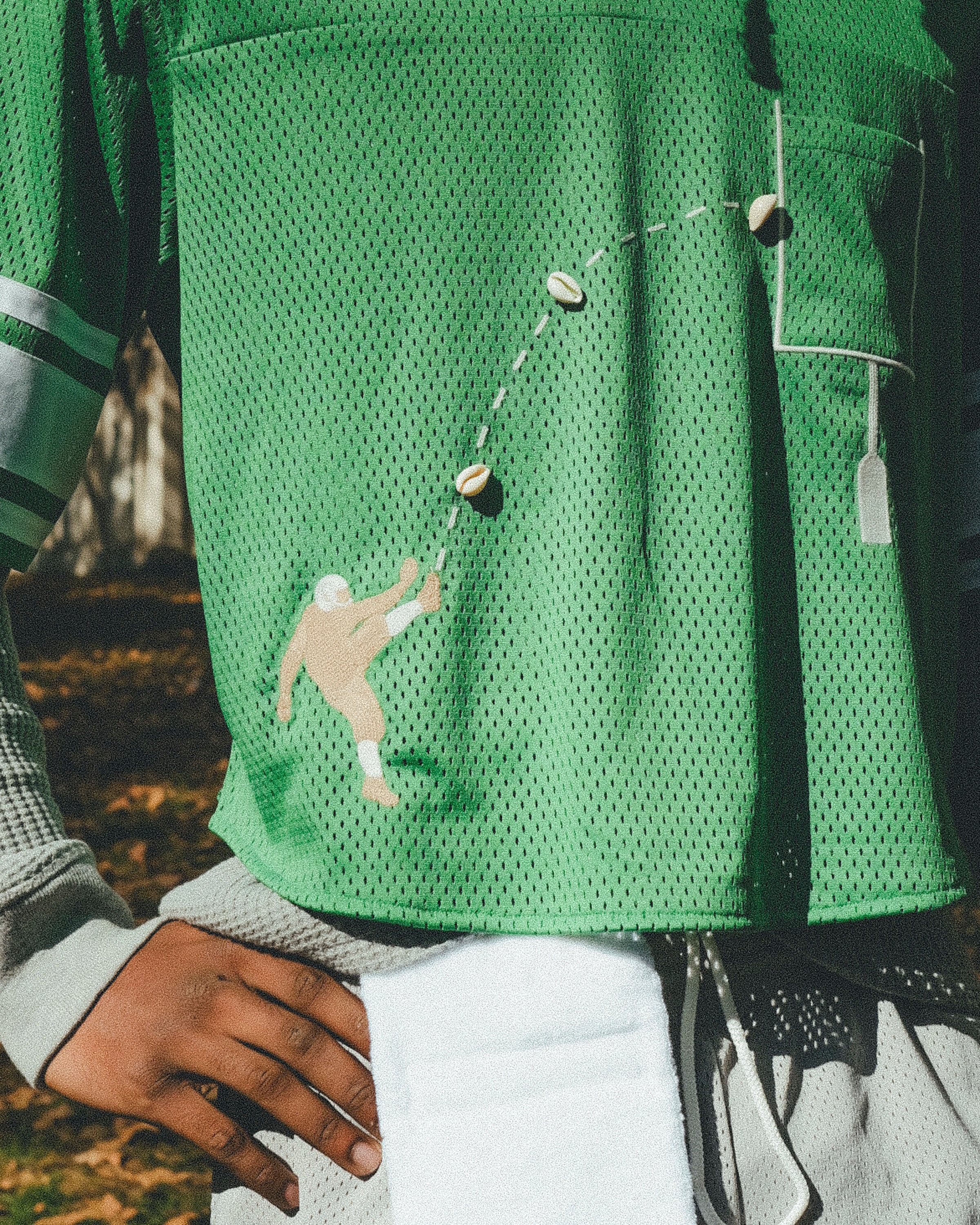 Close-up of embroidered football player kicking a football.