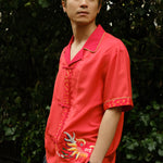 Jiannan looks off camera to his left with hands in his pocket