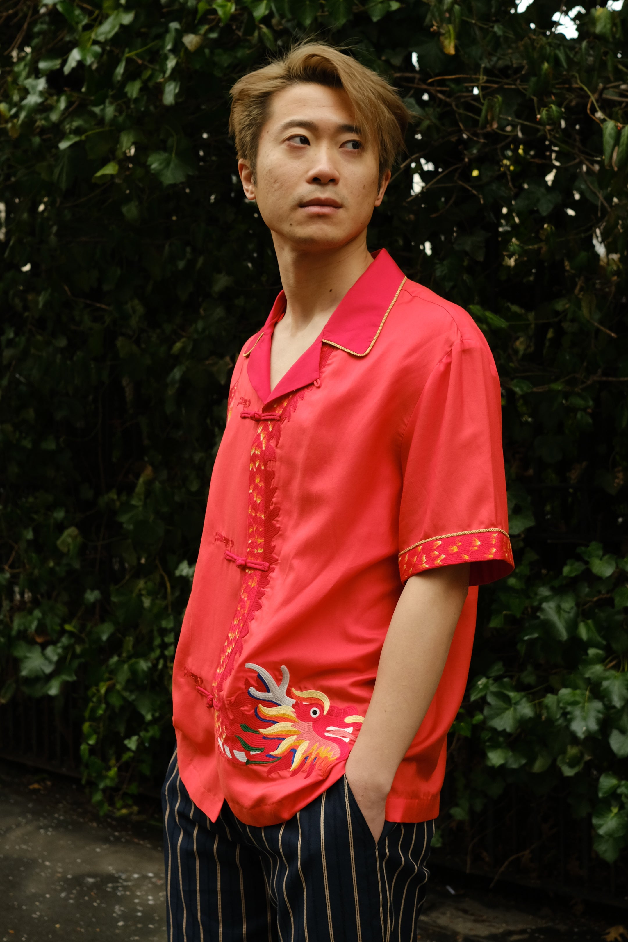 Jiannan looks off camera to his left with hands in his pocket