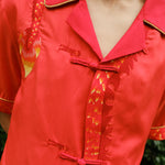 Close up of shirt showing the detailed dragon embroidery and traditional frog button enclosures