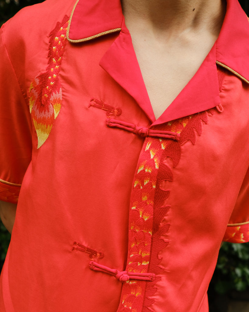Close up of shirt showing the detailed dragon embroidery and traditional frog button enclosures