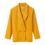 A vibrant yellow corduroy jacket with a relaxed, double-breasted fit. It features two front buttons, wide notch lapels, and two large front patch pockets with flaps. The inside collar has “Tombolo” embroidered in cursive.