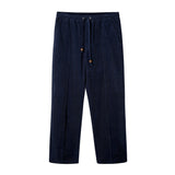 Navy corduroy pants with an elastic waistband and drawstrings, featuring a zippered side pocket.