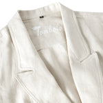 Lapels of beige linen suit showing Tombolo embroidery