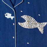 Close-up image of the 'Teamwork' Cabana ~ Crop Cut's left panel which features fish-shaped buttons that have been carefully assembled into the shape of a larger fish.