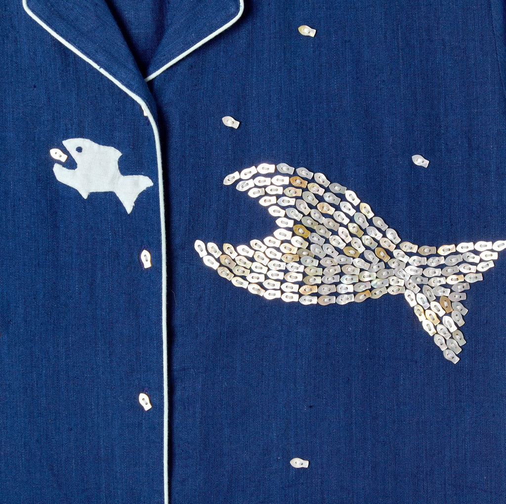 Close-up image of the 'Teamwork' Cabana ~ Crop Cut's left panel which features fish-shaped buttons that have been carefully assembled into the shape of a larger fish.