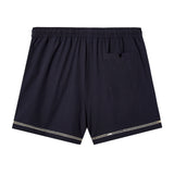 Back side of swim trunks against white background showing the signature V pocket