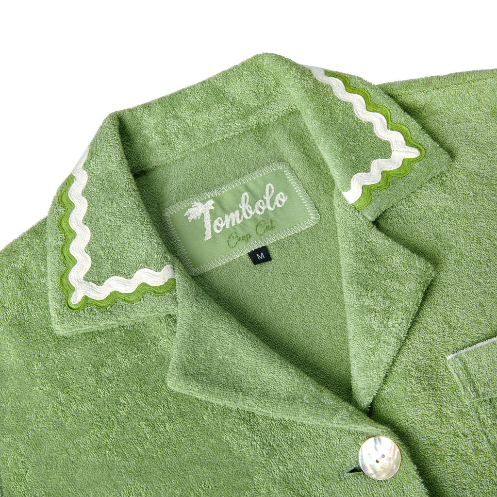 Close-up product image of the 'Rick Rack' Cabana ~ Crop Cut's (Green) custom interior woven label and oversized agoya shell buttons.