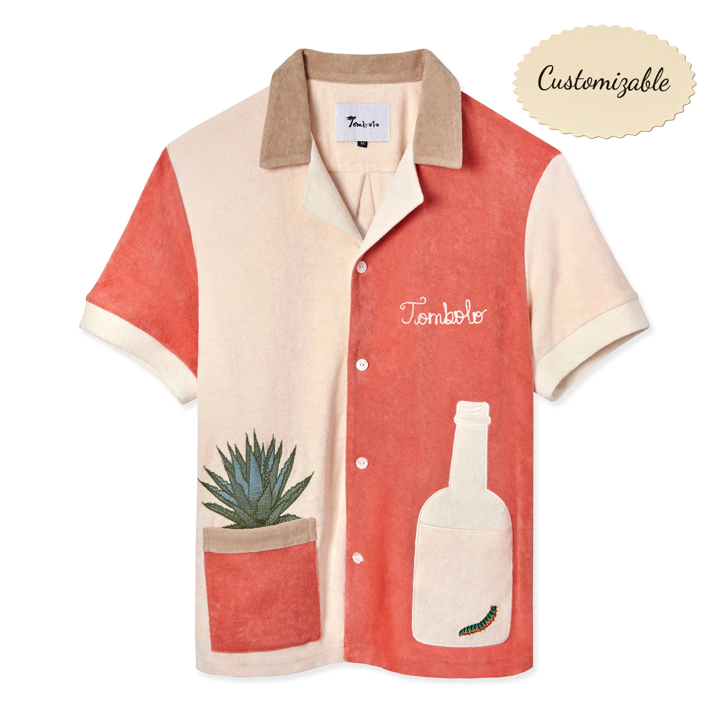A short-sleeved '¡Gusanito!' Cabana shirt in beige and red, featuring embroidered agave and gusano designs, and a bottle-shaped pocket. Also includes 'Tombolo' embroidery on the chest.