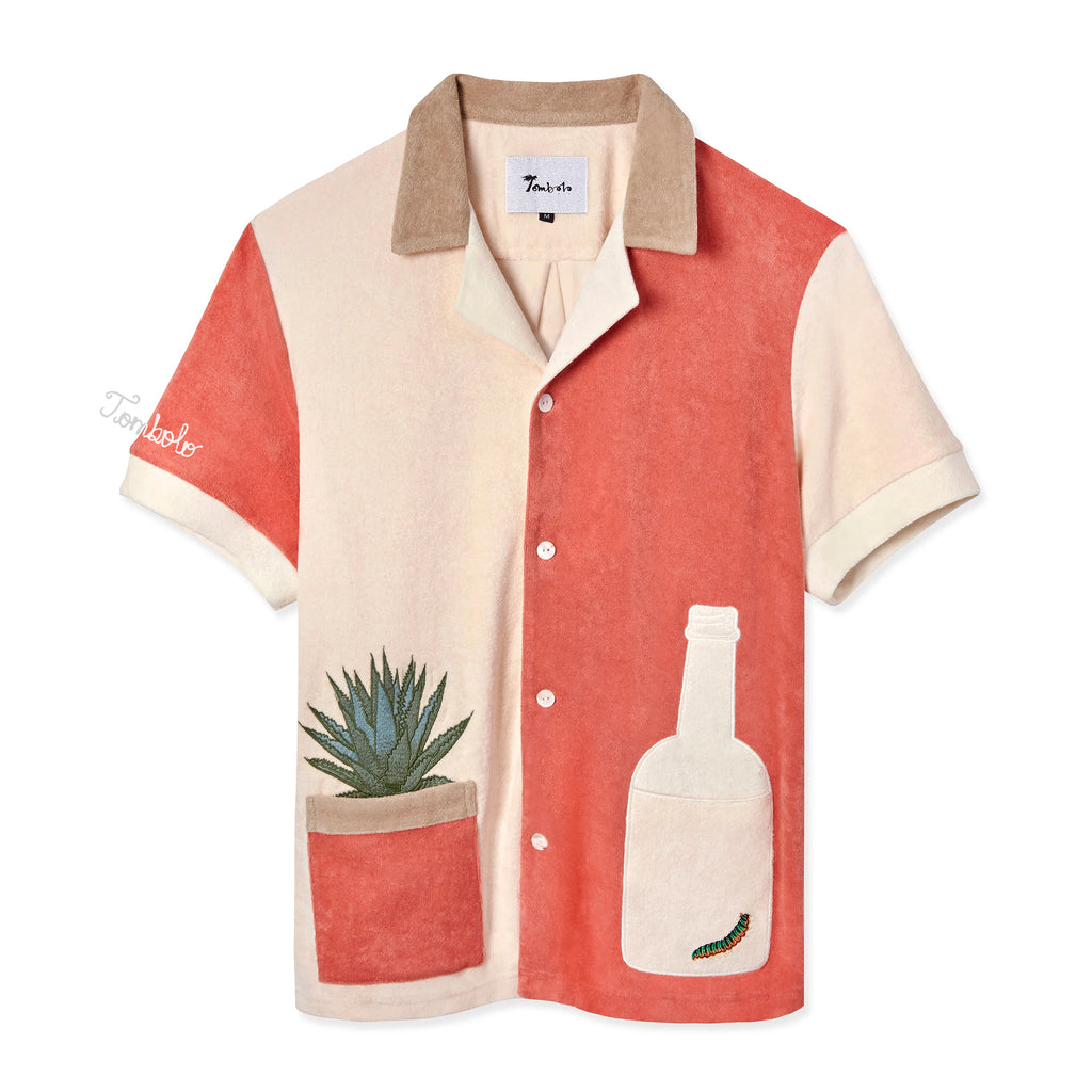 A short-sleeved '¡Gusanito!' Cabana shirt in beige and red, featuring embroidered agave and gusano designs, and a bottle-shaped pocket. Also includes 'Tombolo' embroidery on the sleeve.