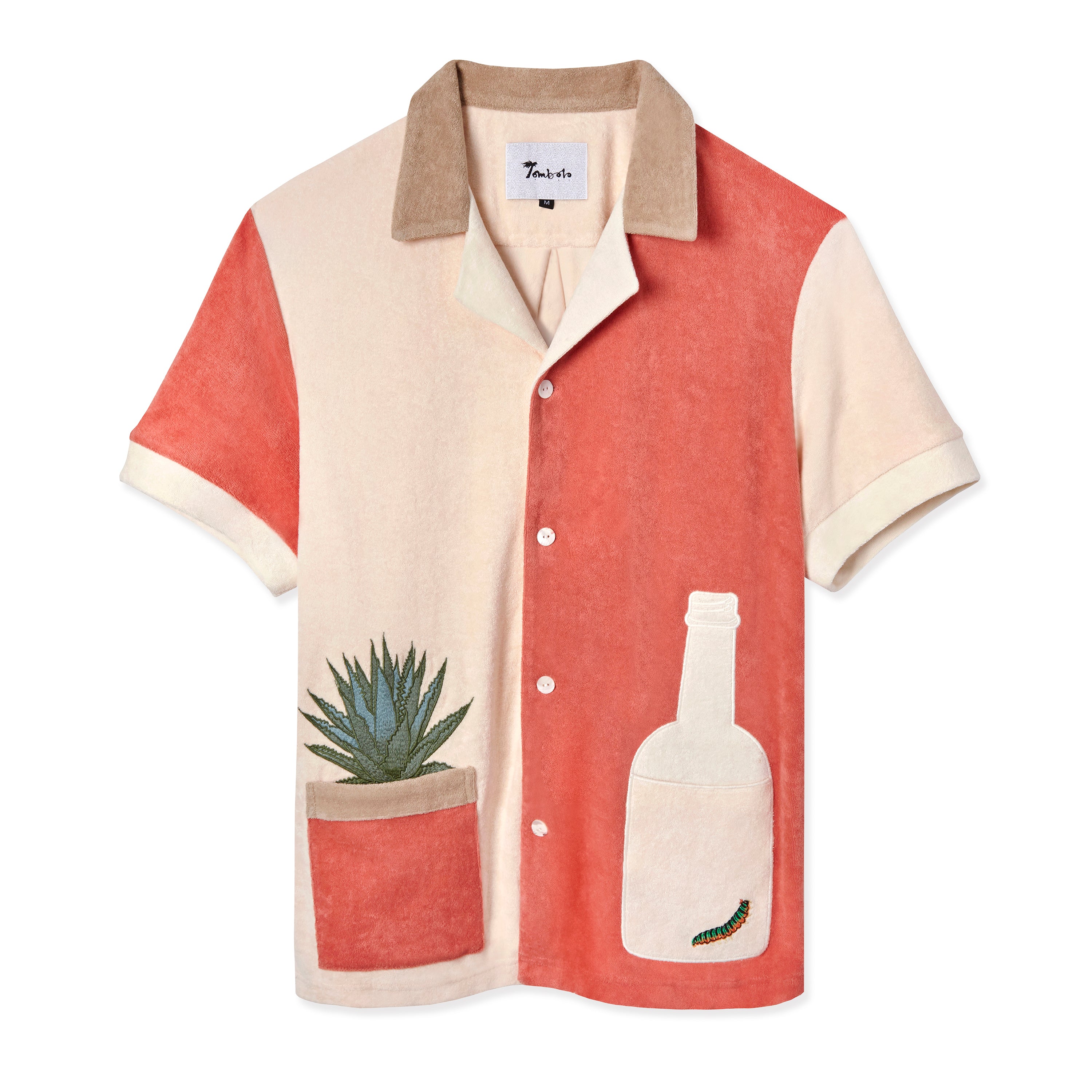 Tombolo salmon and light pink cotton terry cloth shirt with a light pink tequila bottle with a green worm inside on the right and an agave plant in a salmon colored pot on the left side, has a beige collar and four white buttons