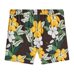 Backwards-facing product image of "Night Bloom" swim trunks with vintage print featuring columns of palms and hibiscus flowers that showcases the Tombolo signature 'V' back pocket