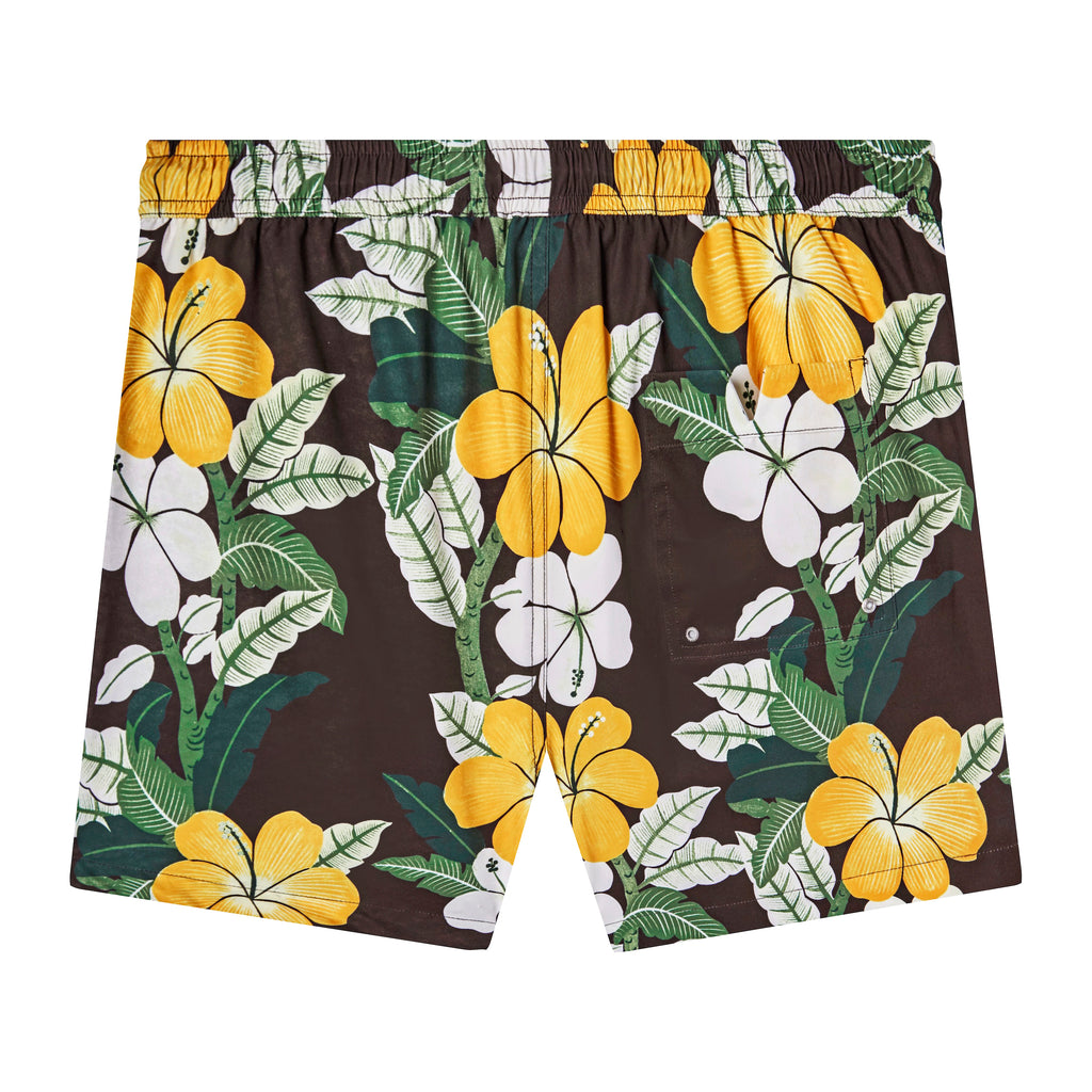 Backwards-facing product image of "Night Bloom" swim trunks with vintage print featuring columns of palms and hibiscus flowers that showcases the Tombolo signature 'V' back pocket