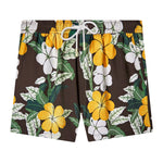 Front-facing product image of "Night Bloom" Swim Trunks that features its hibiscus pattern with yellow and white accents on a brown base in addition to a white drawstring with metal eyelet stoppers and zippered pockets.