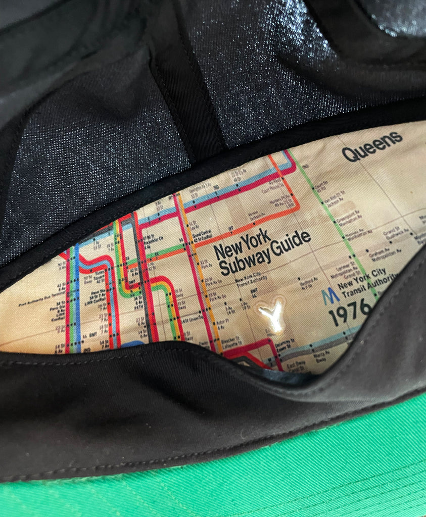 Inside panel of cap showing New York subway guide