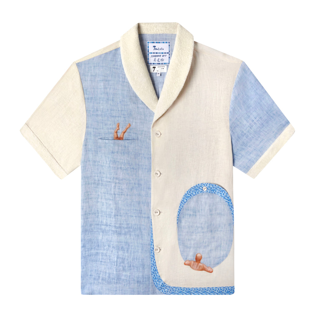 A unique short-sleeved shirt featuring appliquéd elements from Jiannan Wu's Untitled, celebrating Chinese bathing culture. It's crafted from 100% organic cotton with a terry cloth shawl collar and cuffs in an oatmeal hue, contrasted with pale blue chambray fabric. The shirt showcases an imaginative trompe-l'oeil design: a slit chest pocket with a small appliquéd figure of a bather diving in and a large lower pocket shaped like a hot tub with a lounging bather.
