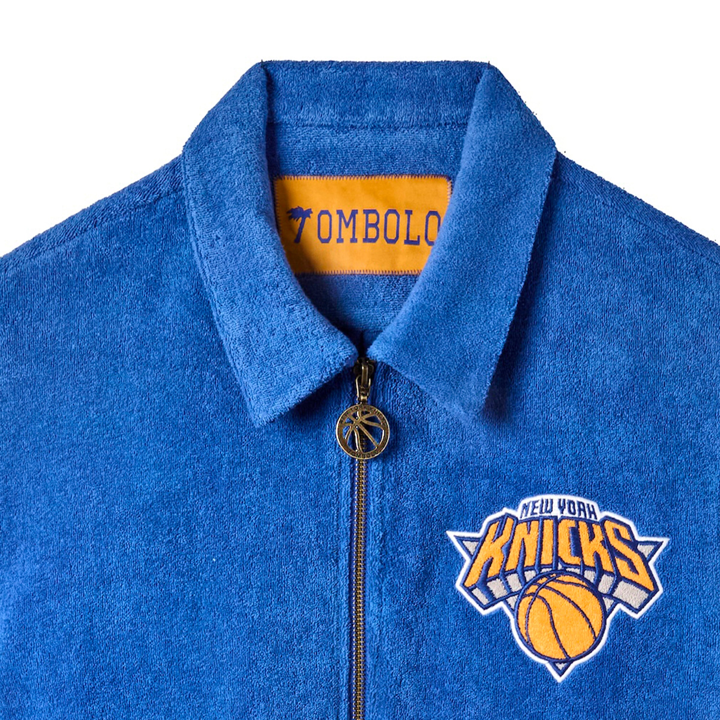 Close-up image of the NY Knicks logo and the basketball zipper feature. 