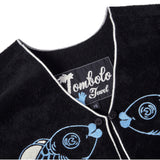 Close-up product image of the 'fish smooch' hand towel top's interior label tag.
