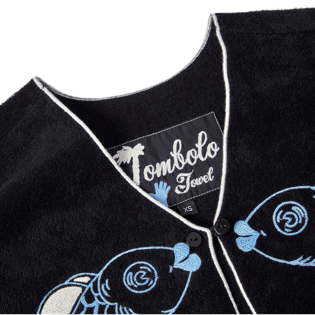 Close-up product image of the 'fish smooch' hand towel top's interior label tag.