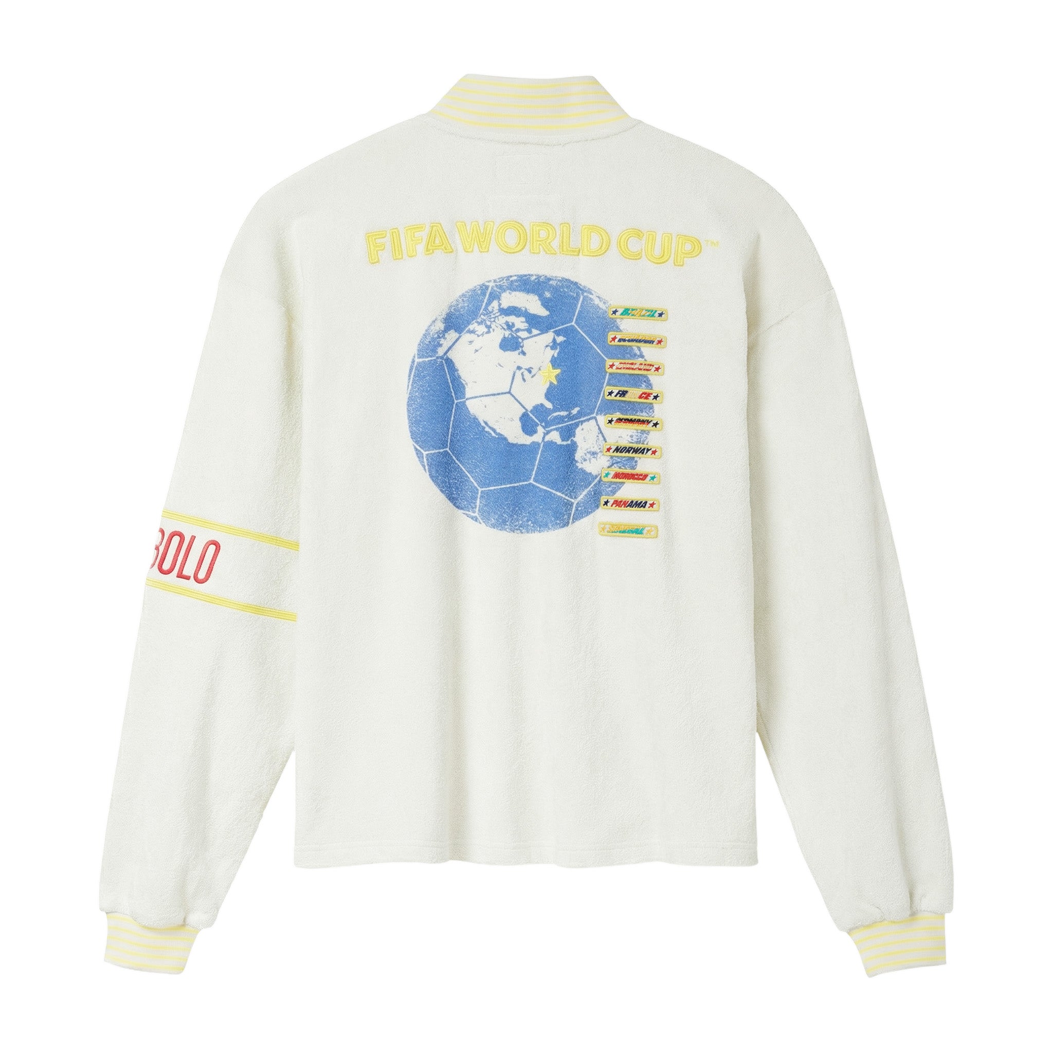 Back view of cream long-sleeve quarter-zip shirt with yellow “FIFA World Cup” lettering and large blue globe graphic with team list on the back, plus striped yellow ribbed collar and cuffs.