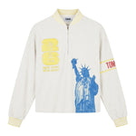 Front view of a cream terry quarter-zip pullover with FIFA embroidery, a blue Statue of Liberty graphic, and a Tombolo logo sleeve patch.
