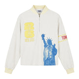 Front view of a cream terry quarter-zip pullover with FIFA embroidery, a blue Statue of Liberty graphic, and a Tombolo logo sleeve patch.
