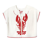 Front-facing product image of the 'Better Half' Hand Towel Top made of 100% Organic Terry Cloth that features a large lobster halved by the chain-stitched front opening, red picot trim frames, a loop button closure at the sternum, Two additional concealed hook-and-eye closures that can be fastened shut to prevent the front panels from fluttering open, and an interior label that is chain-stitched with a hand motif