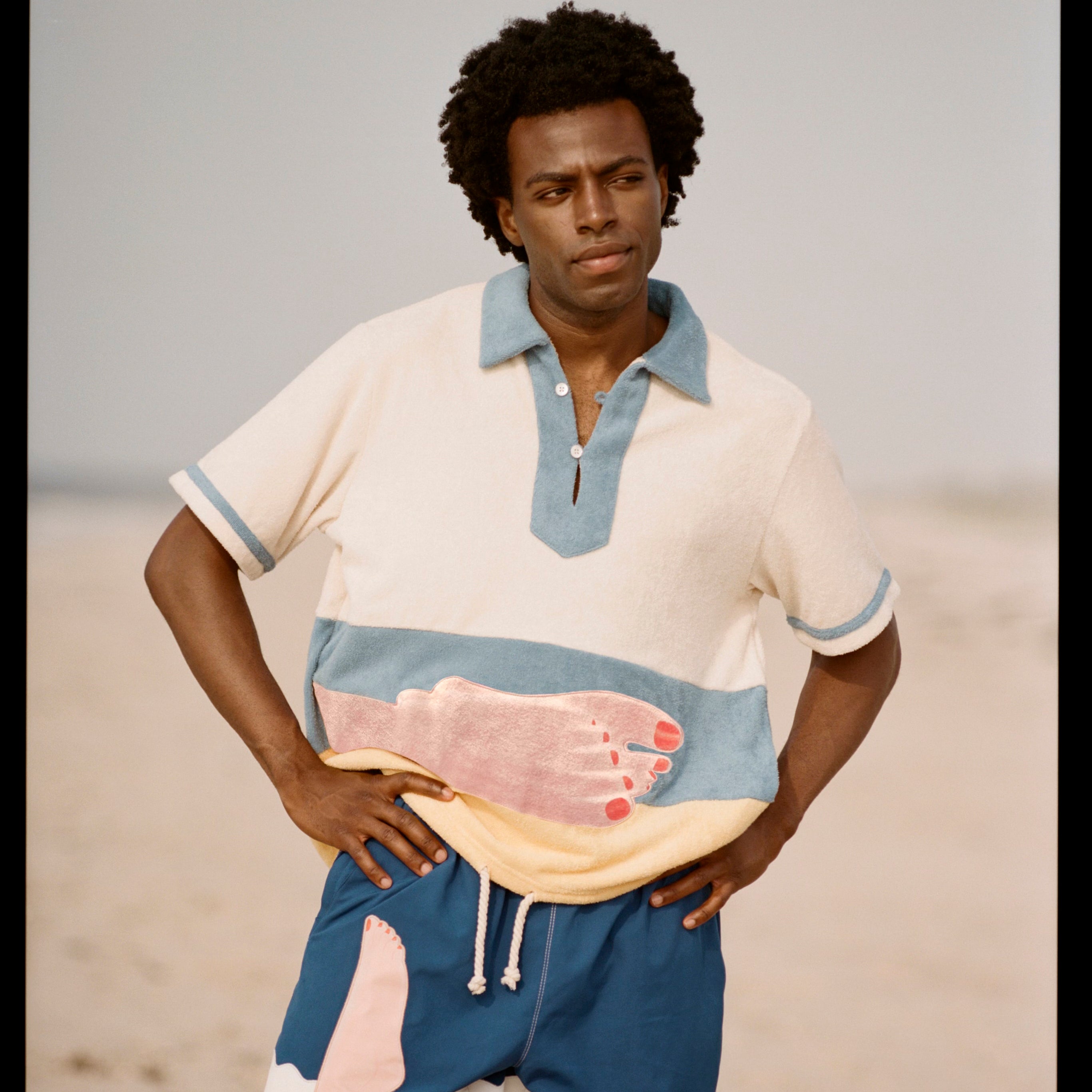 Model stands with hands on hips looking off camera