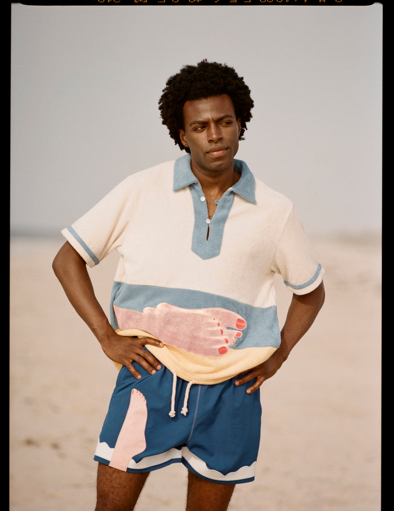 Model stands with hands on hips looking off camera