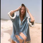 Woman wearing poncho with hood up