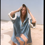 Woman wearing poncho with hood up