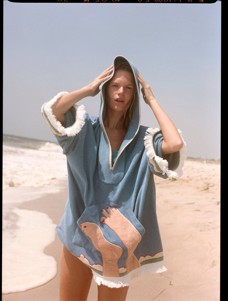 Woman wearing poncho with hood up