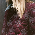 close up of maroon quilted jacket