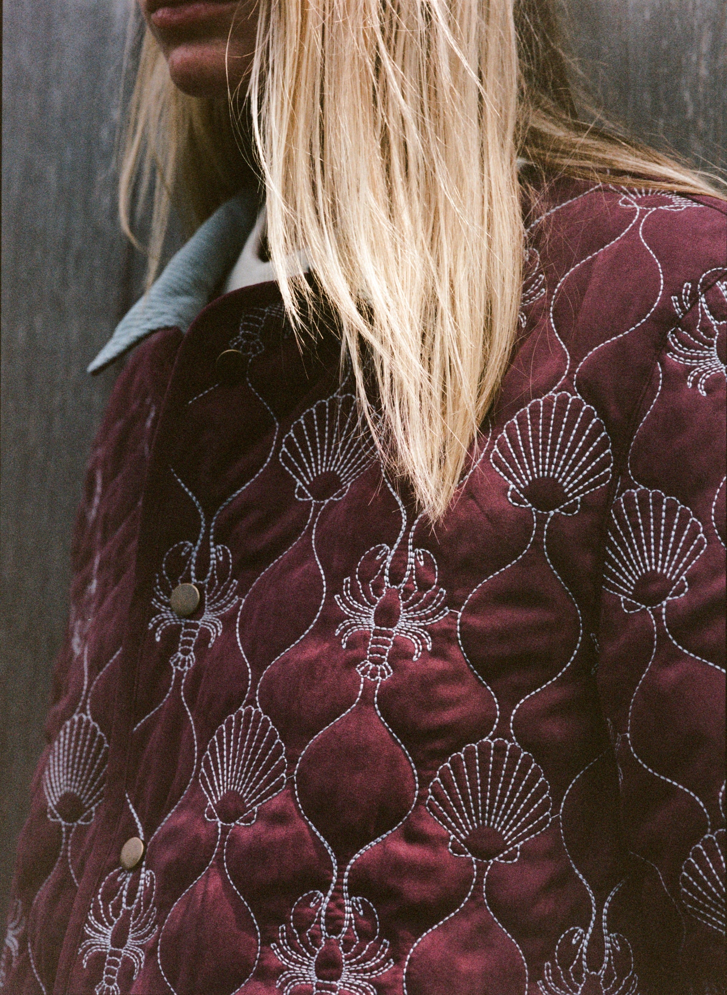 close up of maroon quilted jacket