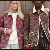 Man and woman stare at camera in quilted jackets