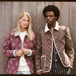 upper body shot of man and woman wearing quilted jackets