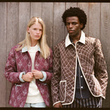 upper body shot of man and woman wearing quilted jackets
