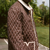 Man wears jacket with picture cropped below his eyes