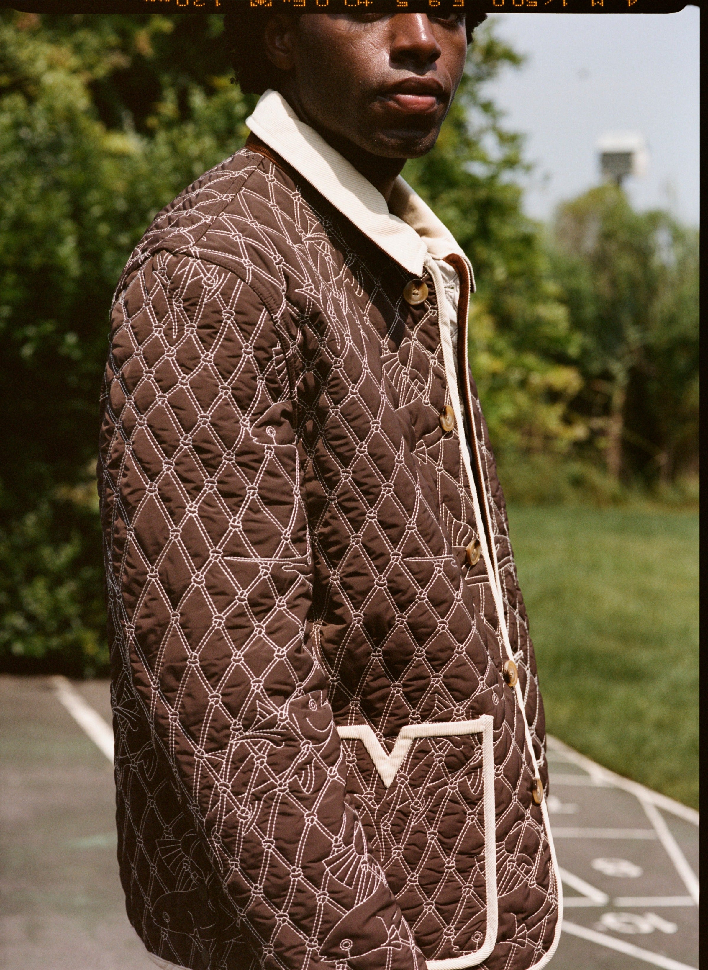 Man wears jacket with picture cropped below his eyes