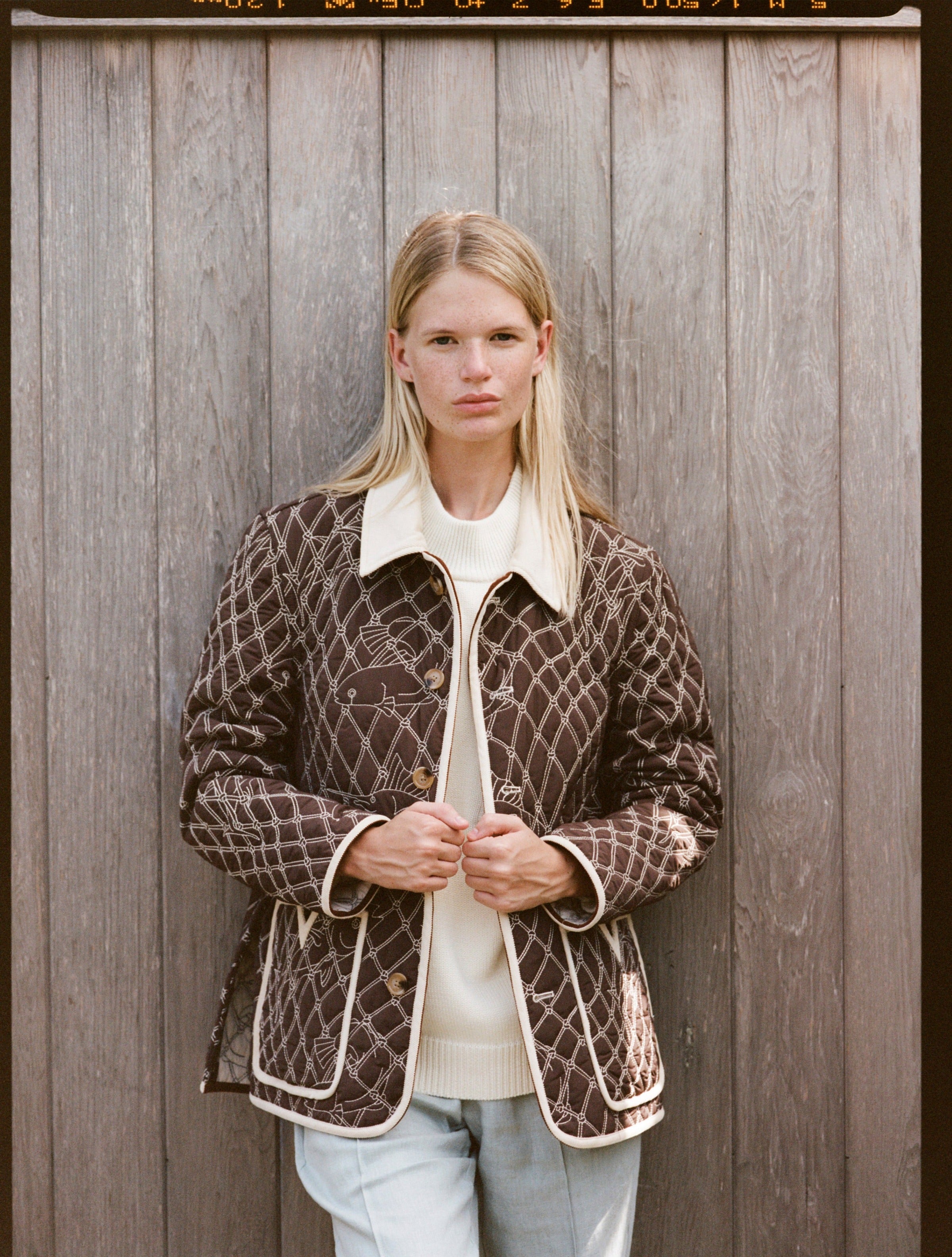 Woman wears unbuttoned jacket